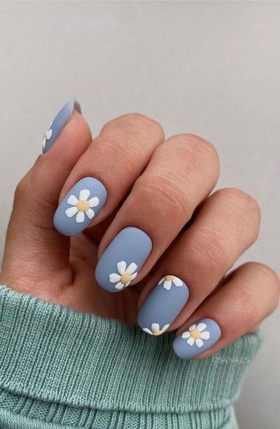 Ongles bleu clair mat avec fleurs blanches