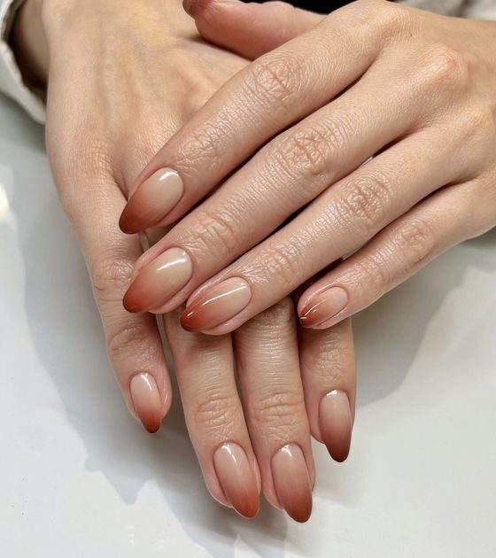 Conception d’ongles à effet ombré beige et brun sur les ongles en amande moyenne