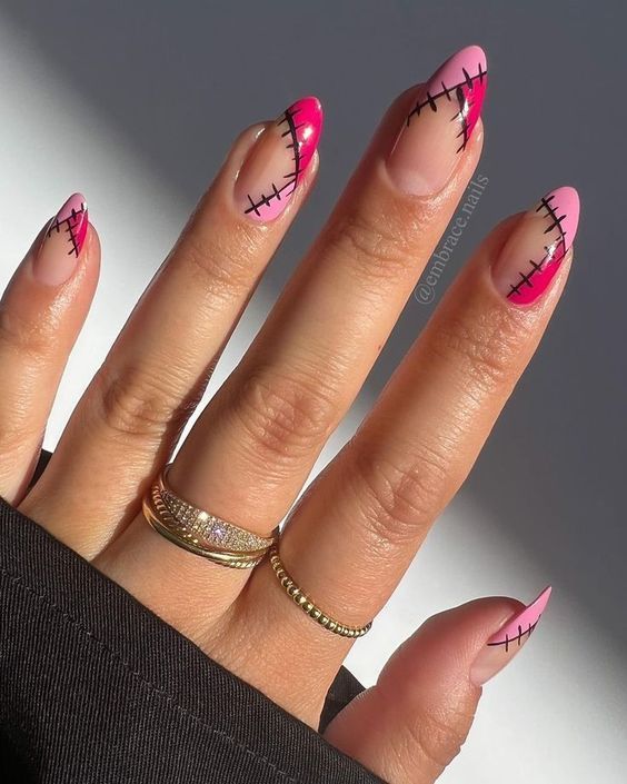 Motifs abstraits rose foncé et rose clair avec des points de nail art sur des ongles en amande moyens