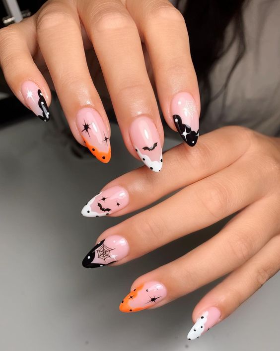 Astuces françaises abstraites noires, blanches et oranges avec des nail arts d’Halloween sur des ongles en amande moyens